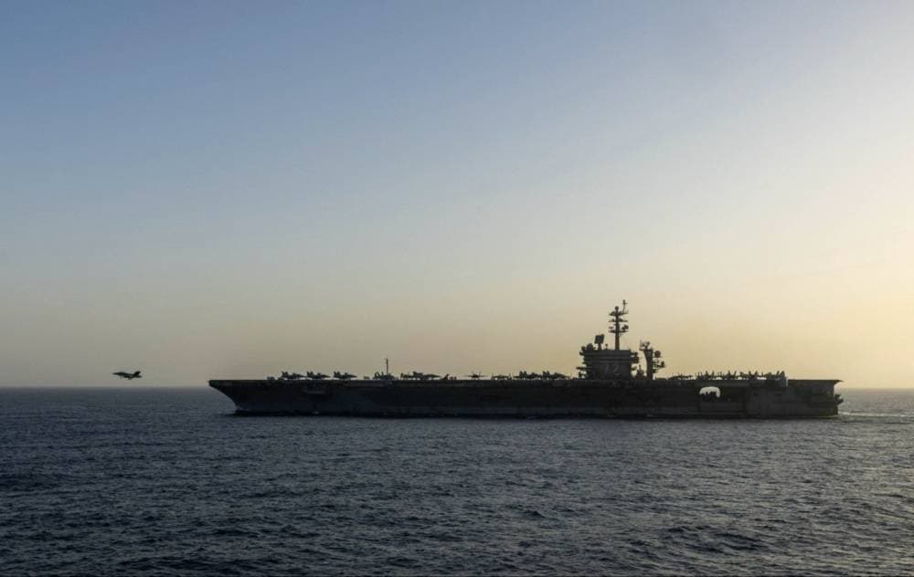 U.S. and Iran flags with military imagery representing conflict escalation