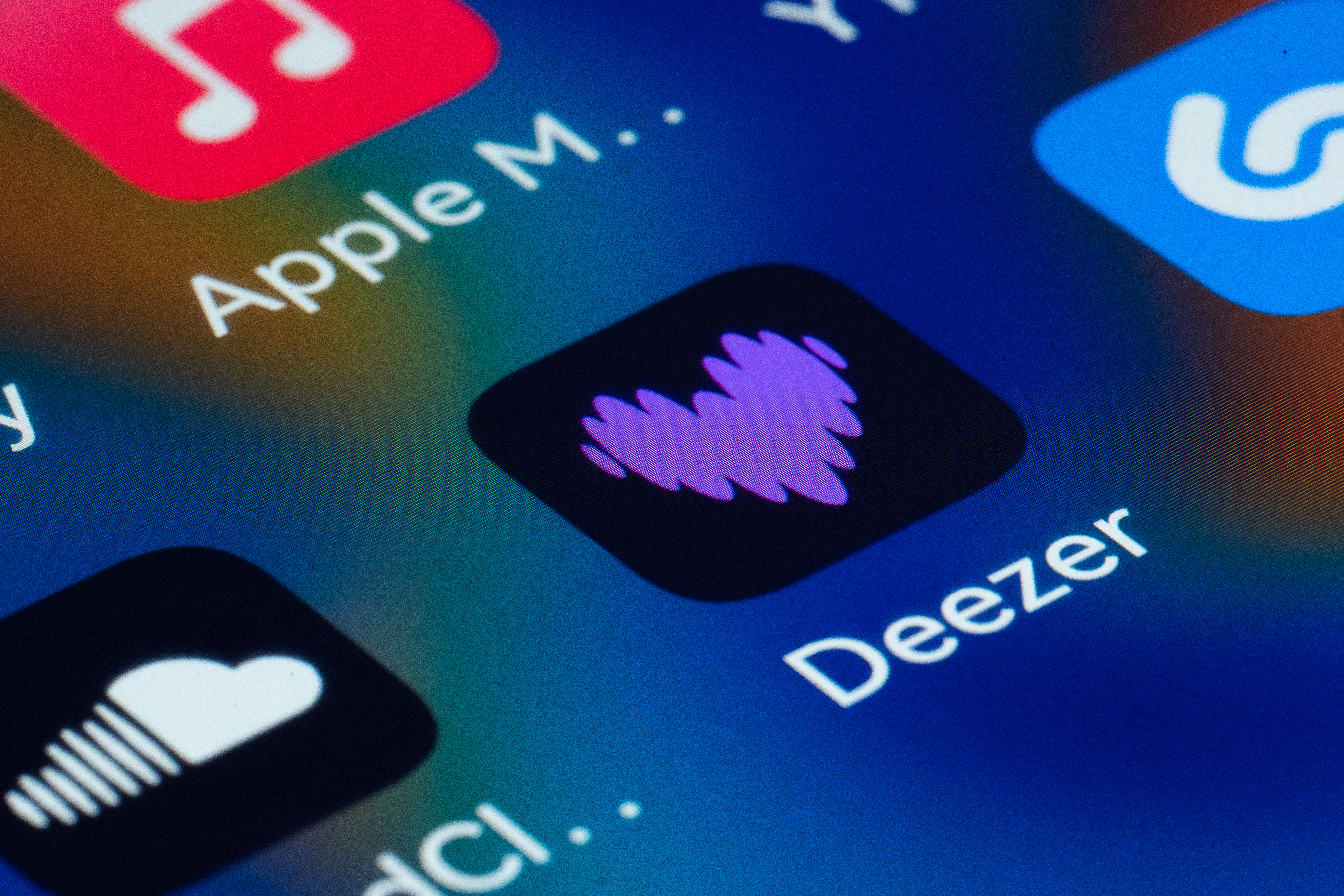 Deezer logo with a visual representation of AI-generated music trends.